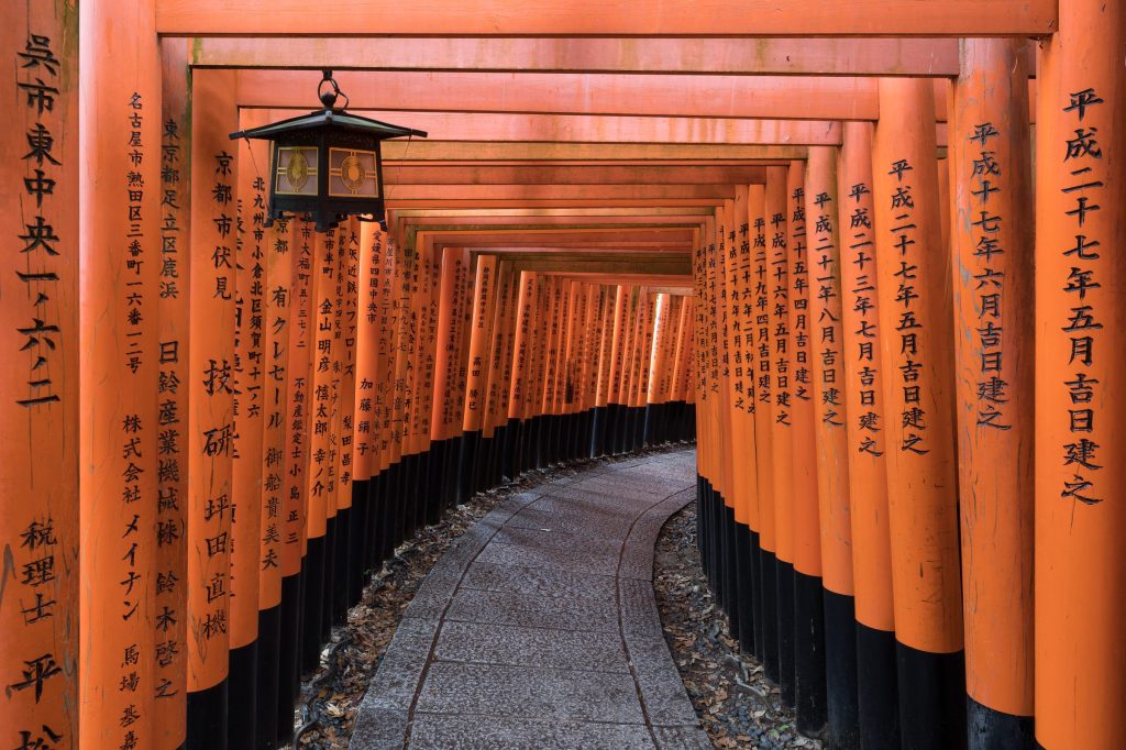 Torii path with lantern at Fushimi Inari Taisha Shrine, Kyoto, Japan by Basile Morin, CC BY-SA 4.0, via Wikimedia Commons